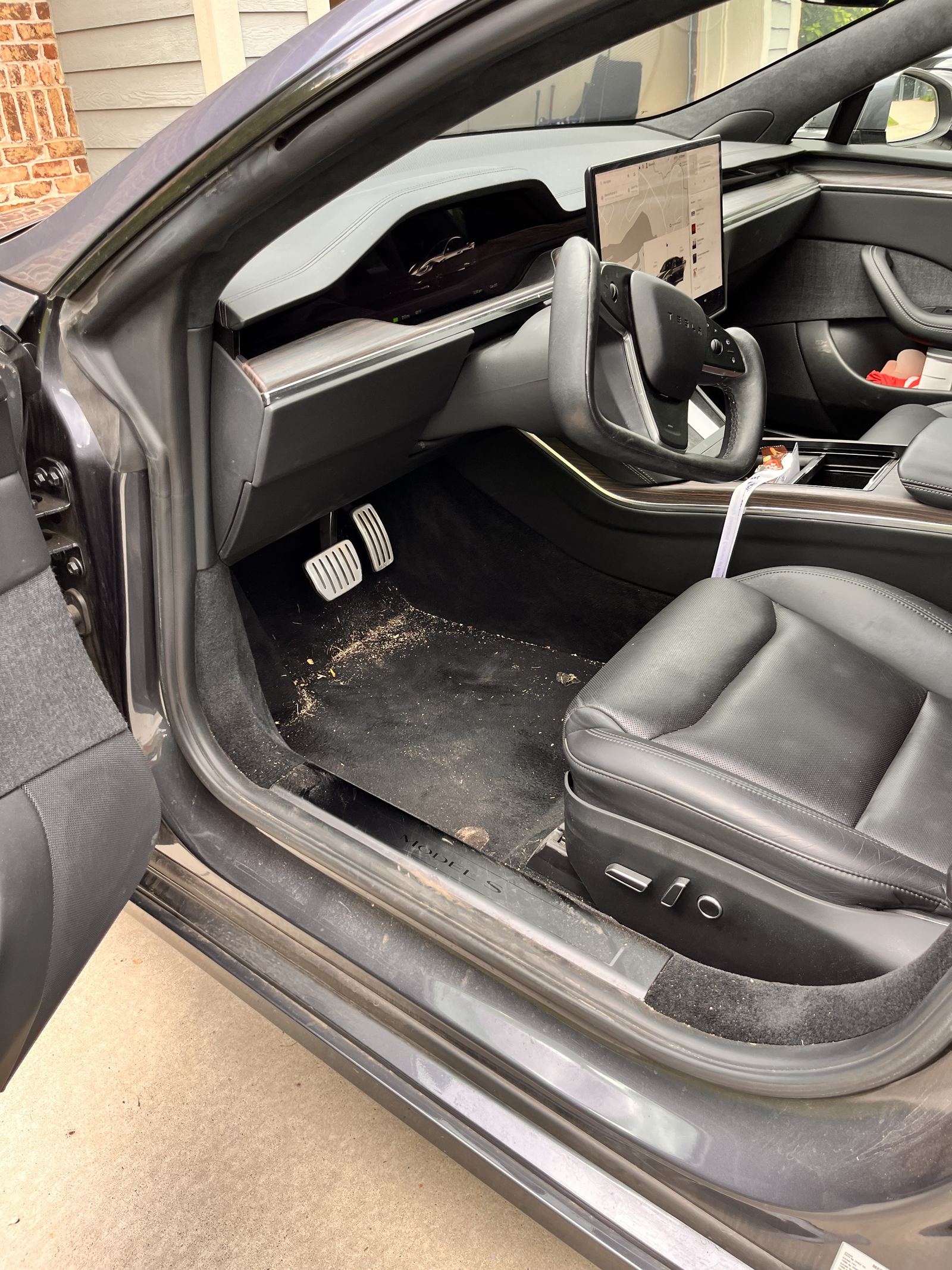 Before detailing — dirty floor mat and debris